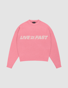 The Live Fast Boucle Sweater by LIVE FAST DIE YOUNG is a pink oversized crewneck with "LIVE FAST" in bold white letters, made from soft polyester knit with long sleeves and ribbed cuffs, waistband, and neckline. | plain