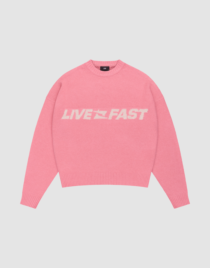 The Live Fast Boucle Sweater by LIVE FAST DIE YOUNG is a pink oversized crewneck with "LIVE FAST" in bold white letters, made from soft polyester knit with long sleeves and ribbed cuffs, waistband, and neckline. | plain