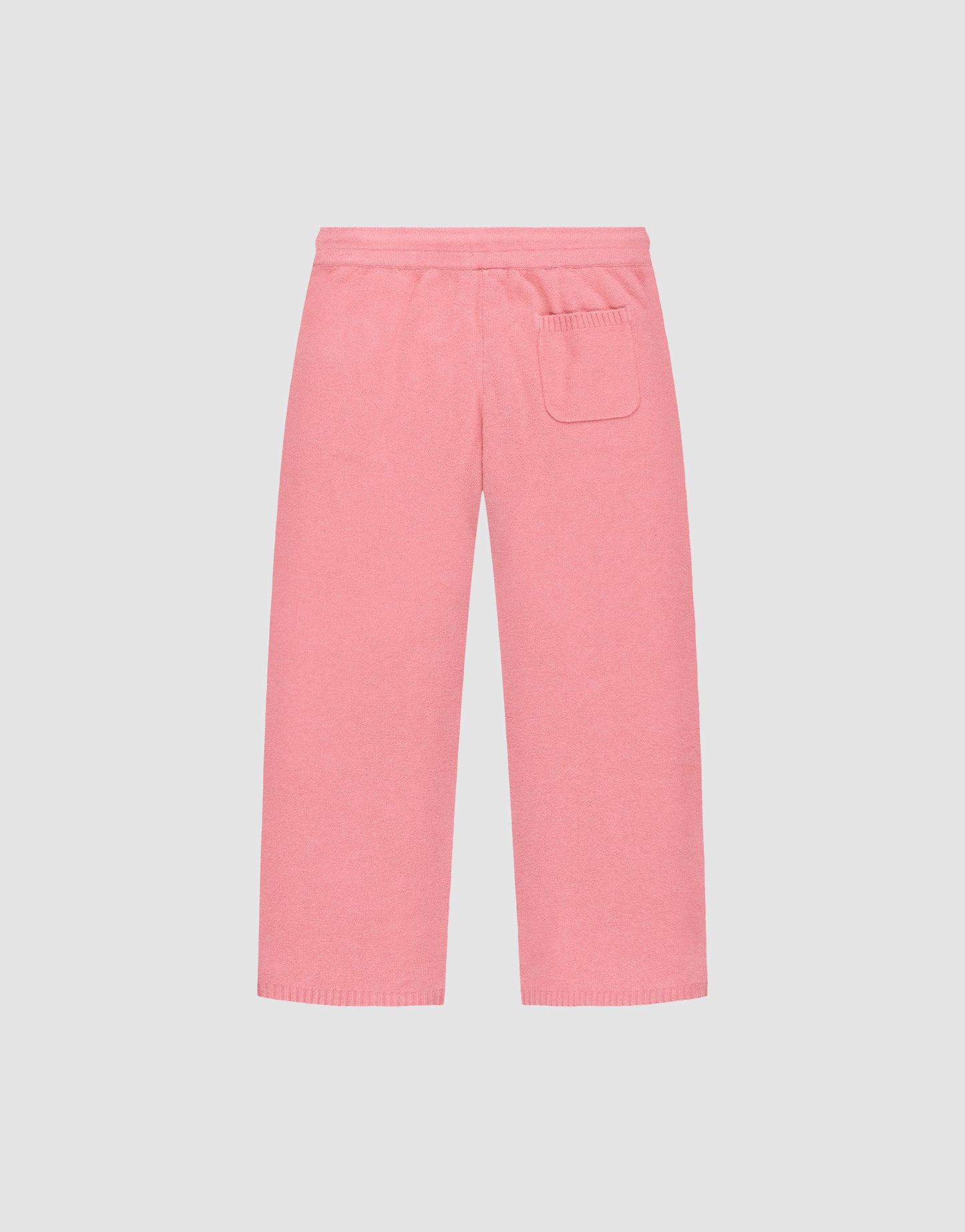 The Live Fast Boucle Pants by LIVE FAST DIE YOUNG are pink knit pants with a wide fit, elastic waistband, straight legs, and a single right patch pocket, shown on a plain light background.