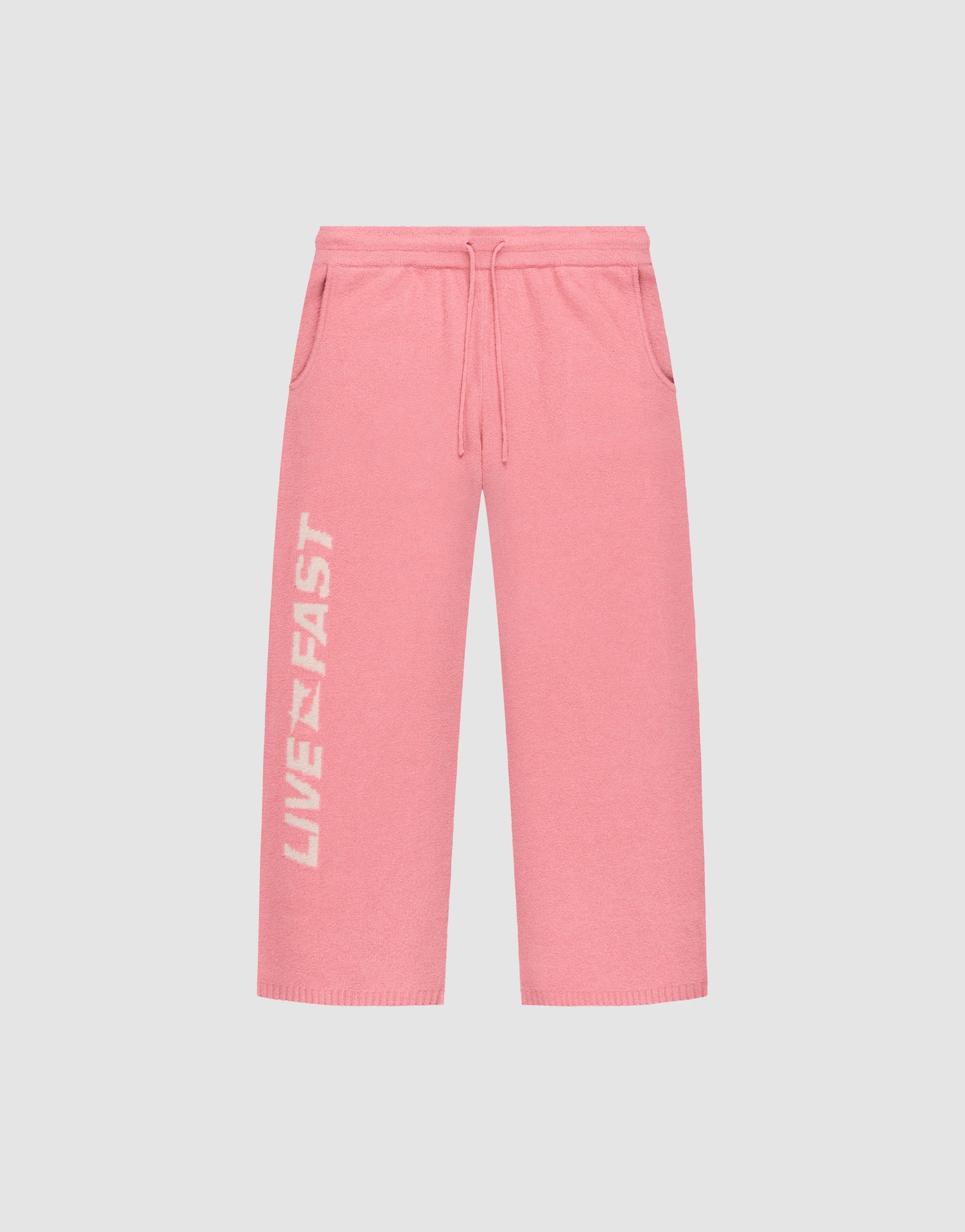 The Live Fast Boucle Pants by LIVE FAST DIE YOUNG feature a wide fit, elastic waistband with drawstring, side pockets, and "LIVE FAST" in white on the left leg—ideal for a relaxed look with a trendy straight-leg silhouette.