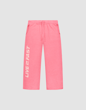 The Live Fast Boucle Pants by LIVE FAST DIE YOUNG feature a bright pink wide fit, elastic waistband, side pockets, and “LIVE FAST” in bold white text vertically on the left leg. | plain
