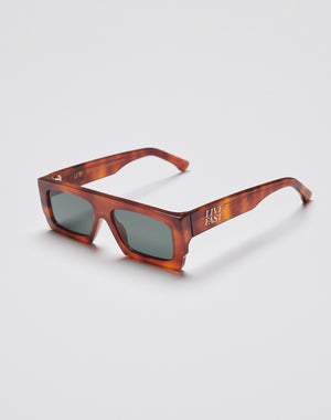 The Live Fast Shades by LIVE FAST DIE YOUNG are chunky rectangular tortoiseshell sunglasses made from premium Mazzuchelli Acetat, featuring dark UV-protective lenses and gold LIVE FAST text with the LFDY logo on the arms.
