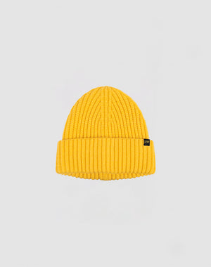 A yellow LIVE FAST DIE YOUNG Rib Knit Beanie, made from cotton with a folded brim and a small black side tag, is shown on a plain light gray background.