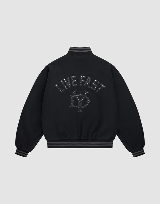 The Live Fast College Jacket by LIVE FAST DIE YOUNG is a black varsity jacket with striped cuffs and hem, a metal zipper, and an embroidered eye with stars and "LIVE FAST" on the back in dark thread. The background is light gray. | plain