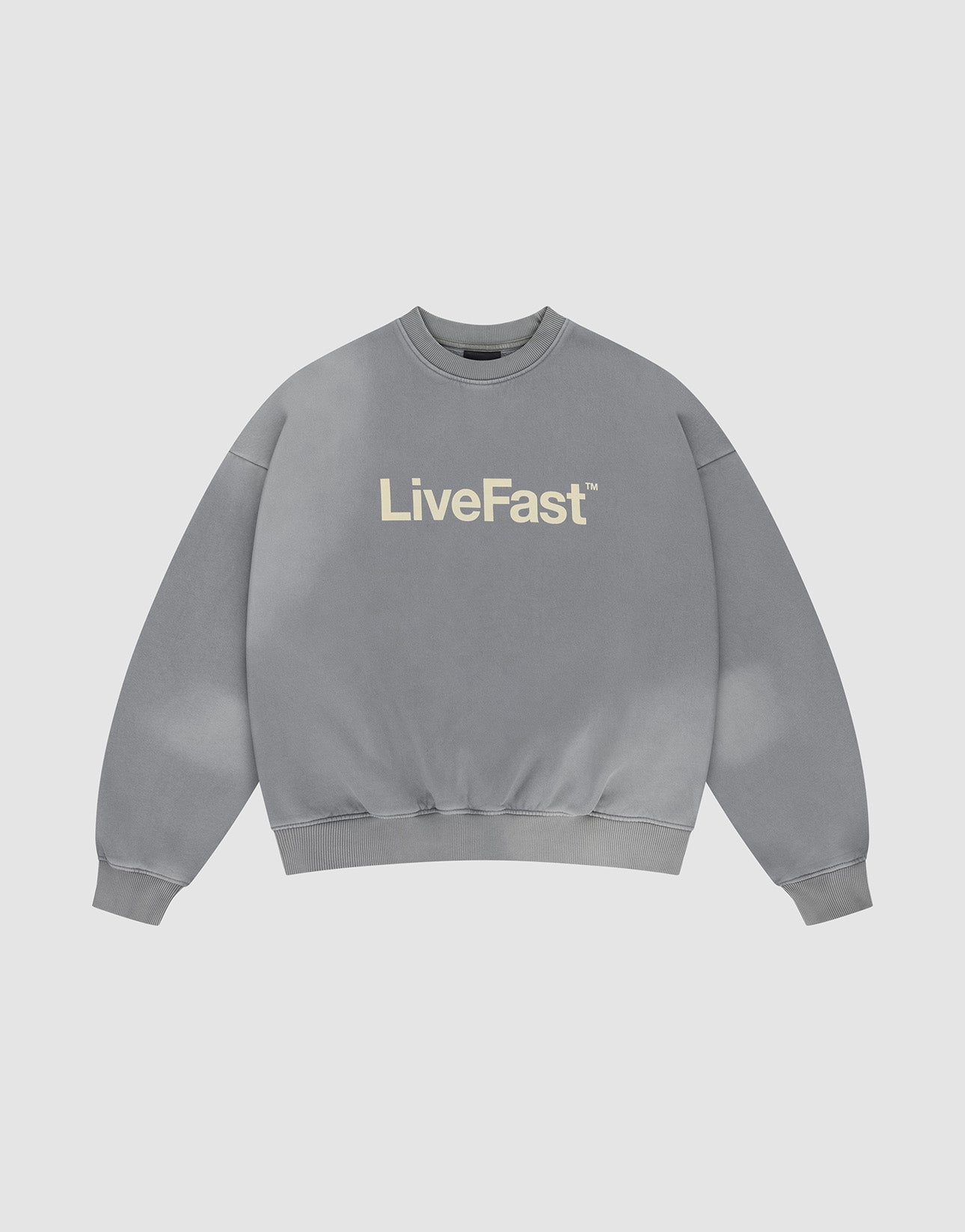 The Basic LiveFast Sweater by LIVE FAST DIE YOUNG is a gray oversized crewneck with “LiveFast” in bold white across the chest, featuring a subtle faded look and shown on a plain light background.
