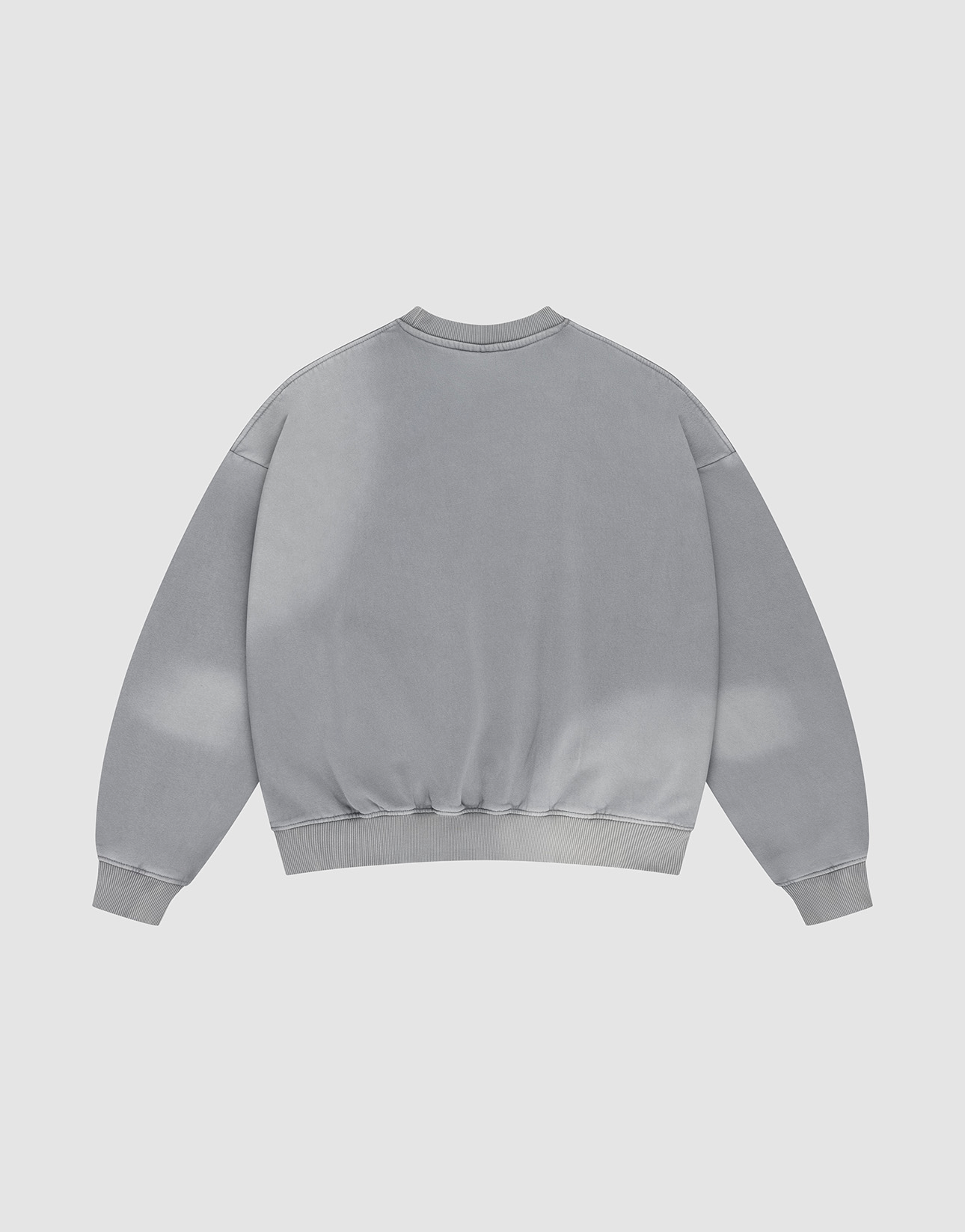 The Basic LiveFast Sweater by LIVE FAST DIE YOUNG is a light gray, oversized crewneck displayed flat with the back up. It features a subtle faded effect, long sleeves, ribbed cuffs and hem for a classic look.