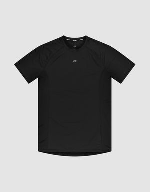 The LFDY Performance Slim Tee by LIVE FAST DIE YOUNG is a black slim-fit, short-sleeve athletic t-shirt with a crew neck and a small white reflective logo print at the center chest, shown against a light gray background. | plain