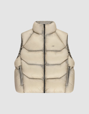 The Live Fast Puffer Vest by LIVE FAST DIE YOUNG features a beige color, high collar, black front zipper, two zippered side pockets, and an oversize fit, shown against a plain light gray background. | plain