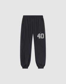 LFDY Performance Trackpants by LIVE FAST DIE YOUNG in black, with elastic waistband and cuffs. Gray reflective "40" and brand print on left thigh, oversize fit. Shown on a plain light gray background. | plain