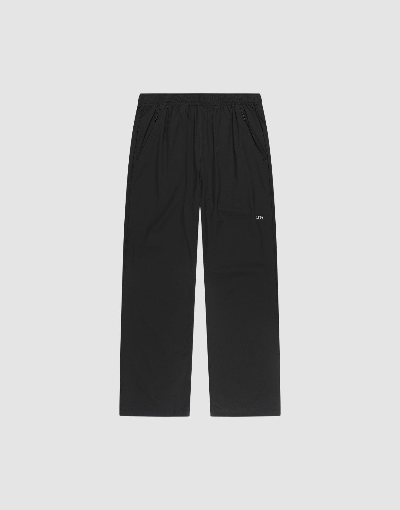 LFDY Performance Pants by LIVE FAST DIE YOUNG, featuring a black straight-leg design with an elastic waistband, side pockets, and a small white LFDY logo on the left thigh, displayed on a plain light gray background.