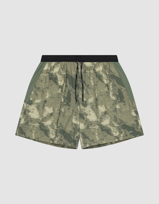 The LFDY Performance Running Shorts by LIVE FAST DIE YOUNG feature a green and beige camo pattern, integrated tights, black drawstring waistband, side panels, and a practical phone pocket, shown against a plain white background. | plain