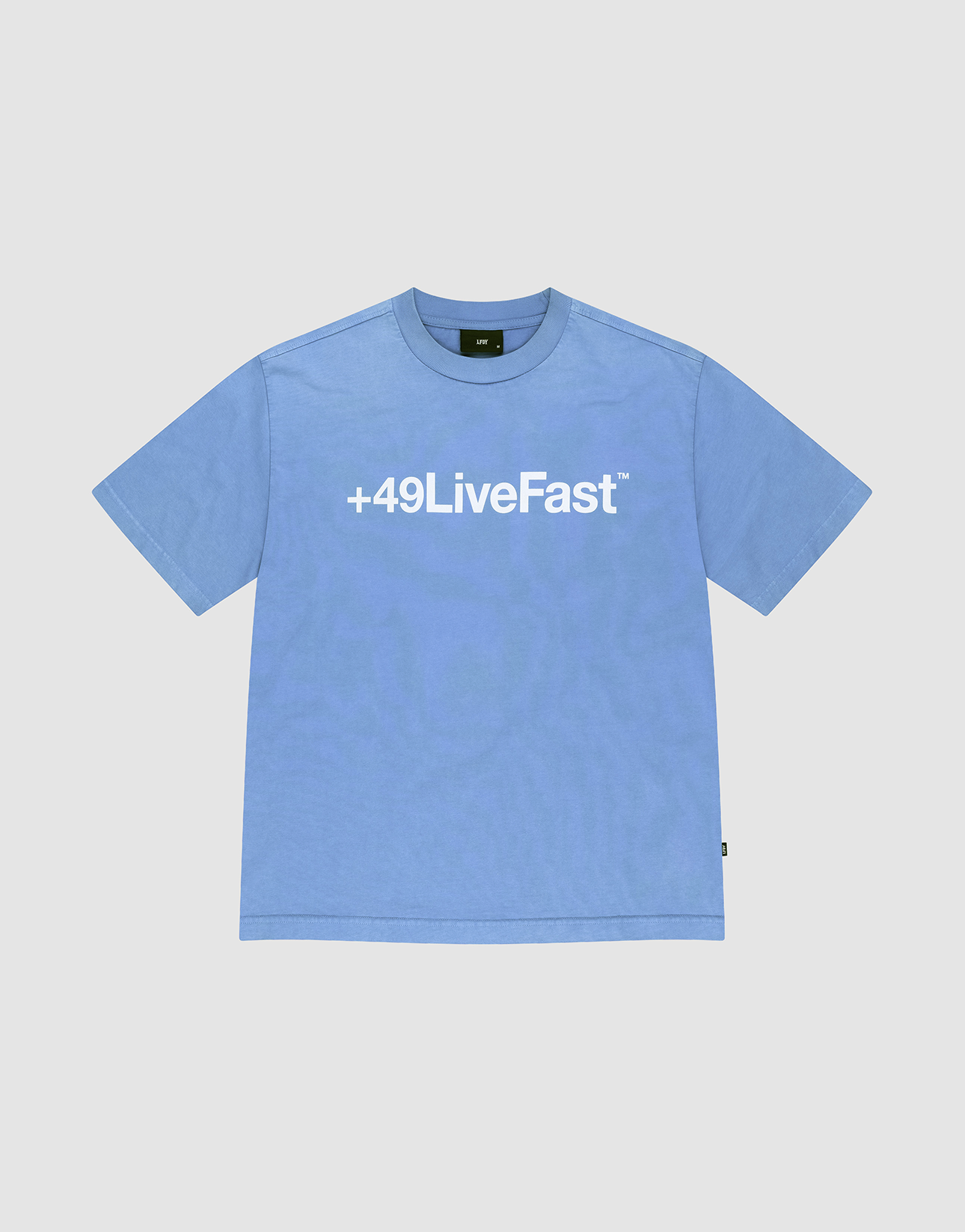 The Basic +49 Tee by LIVE FAST DIE YOUNG is a light blue oversized short-sleeve shirt with a bold white +49LiveFast™ front print, made from 100% Baumwolle and shown flat on a plain white background.
