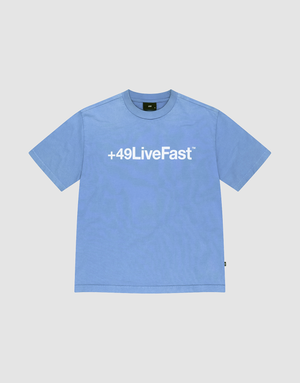 The Basic +49 Tee by LIVE FAST DIE YOUNG is a light blue oversized short-sleeve shirt with a bold white +49LiveFast™ front print, made from 100% Baumwolle and shown flat on a plain white background. | plain