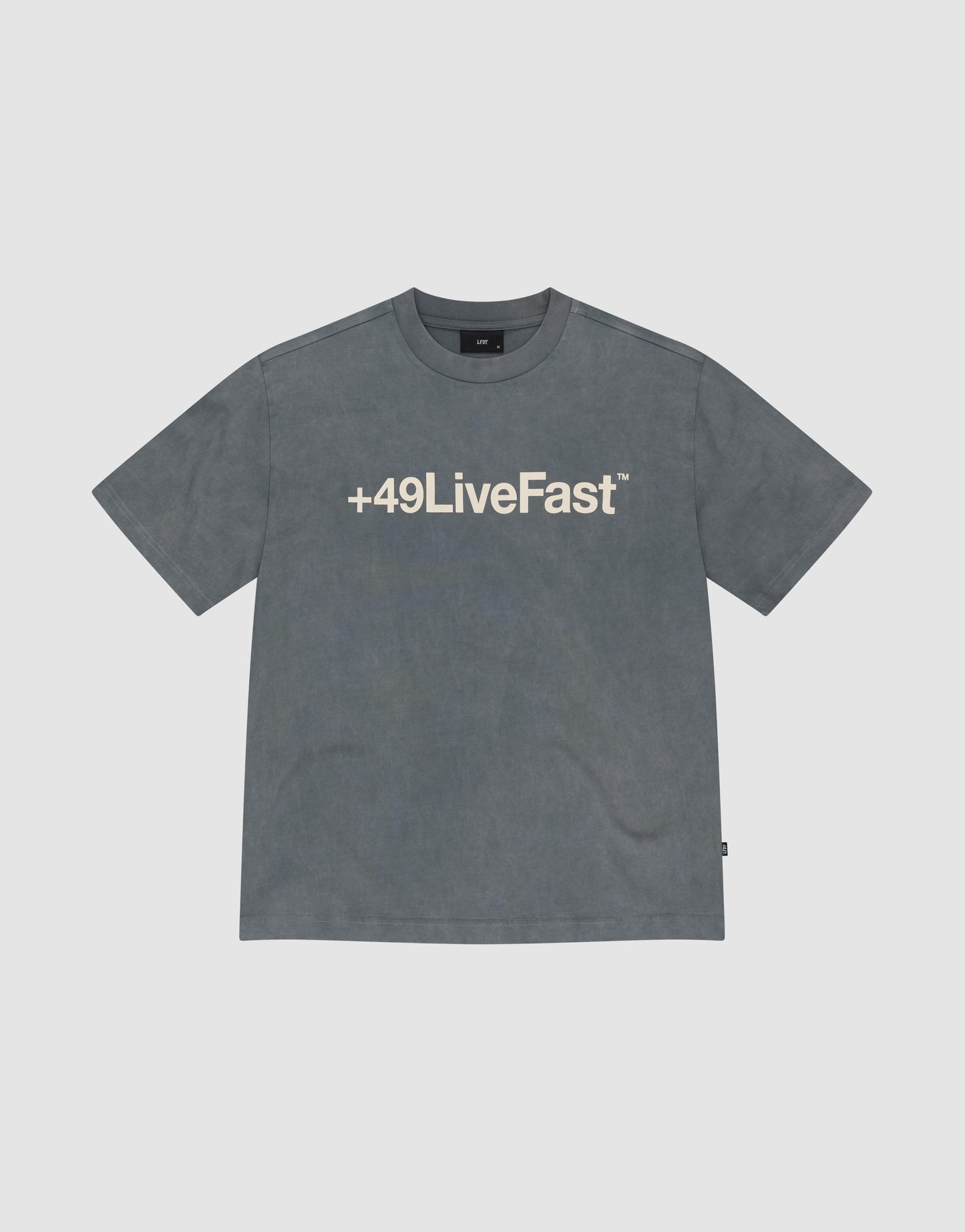The Basic +49 Tee by LIVE FAST DIE YOUNG is a faded gray, oversized t-shirt with a bold front +49LiveFast™ print. Made from 100% cotton, it features short sleeves and a crew neck for casual comfort.