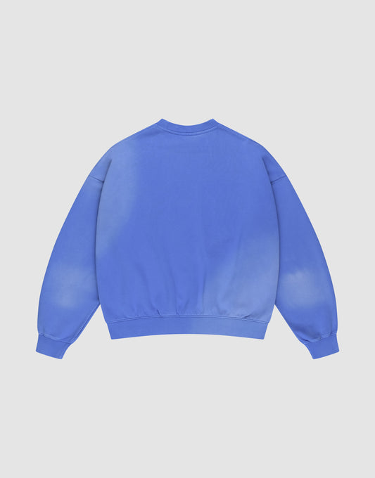 The Basic LiveFast Sweater by LIVE FAST DIE YOUNG is a blue crewneck in Oversize Fit, shown from the back with long sleeves and ribbed cuffs and hem, displayed on a plain light background.