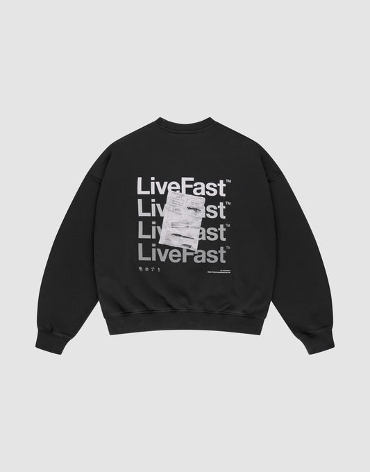The Basic Evidence Sweater by LIVE FAST DIE YOUNG is a black oversized sweatshirt with "Live Fast" printed four times in bold white on the back, front and back prints, a white tag over the print, and made from comfortable cotton-polyester blend. | plain