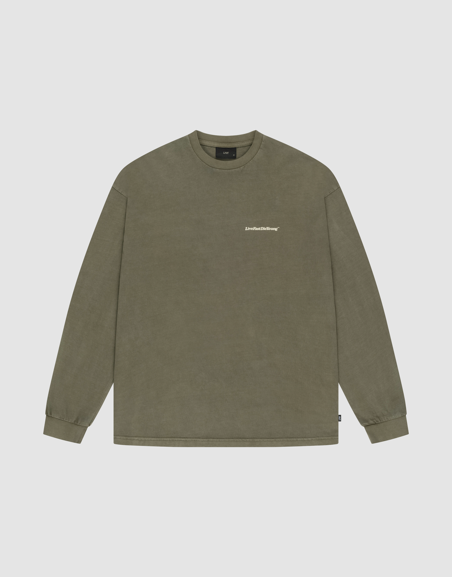 The LIVE FAST DIE YOUNG Basic Longsleeve is an olive-green crewneck with long sleeves, a small white logo on the left chest, made from 100% Baumwolle, shown on a simple light background.