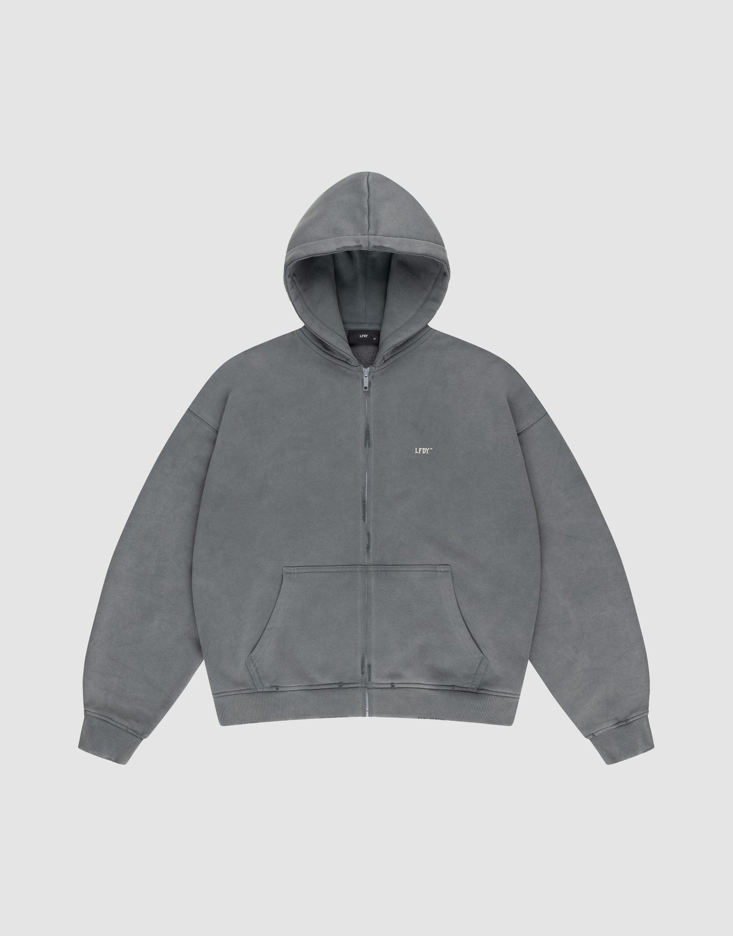 The LIVE FAST DIE YOUNG Basic Hooded Zip is a plain gray oversized hoodie with a zip front, hood, front pockets, and a subtle white “LIFT” logo on the left chest, shown against a light gray background.