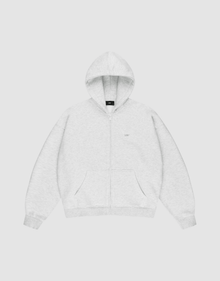 The LIVE FAST DIE YOUNG Basic Hooded Zip is a light gray zip-up hoodie with an oversize fit, front pockets, and a hood. It features subtle LFDY branding on the chest and is shown laid flat on a plain white background. | plain