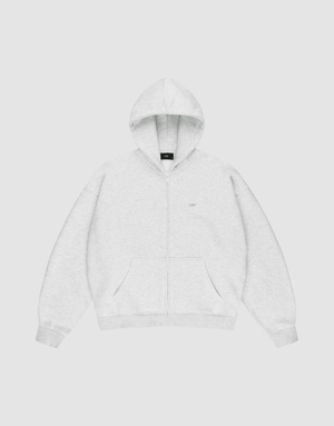 The LIVE FAST DIE YOUNG Basic Hooded Zip is a light gray zip-up hoodie with an oversize fit, front pockets, and a hood. It features subtle LFDY branding on the chest and is shown laid flat on a plain white background. | plain