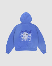 The Basic Evidence Hooded by LIVE FAST DIE YOUNG is a blue oversized hoodie with "LiveFast" printed repeatedly in bold white and purple on the back, topped with a sewn white rectangular patch. Shown laid flat on a white background. | plain