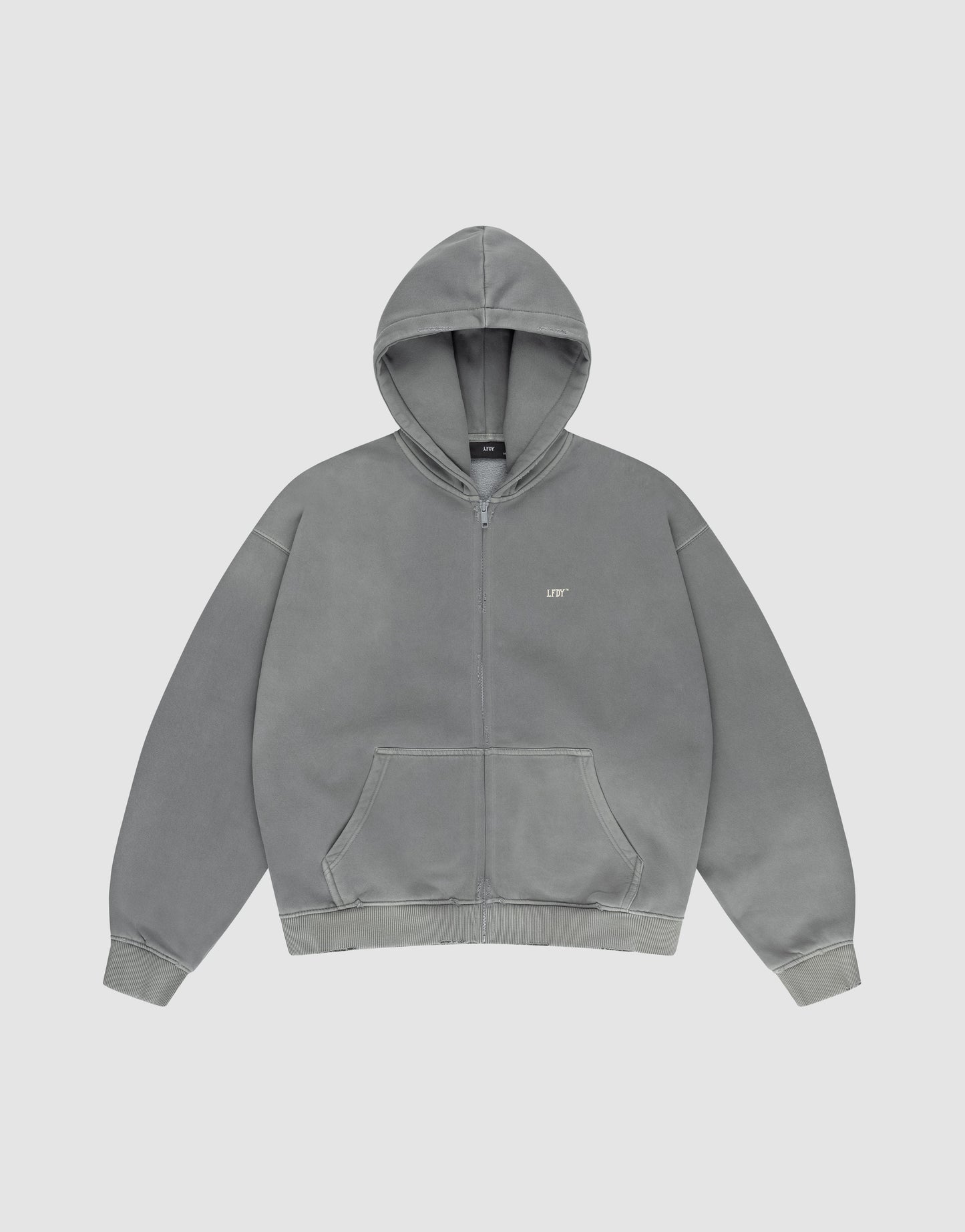 The LIVE FAST DIE YOUNG Basic Hooded Zip is a grey oversized hoodie with a front pocket, hood, and a small white LIFT logo on the left chest, shown against a light backdrop.