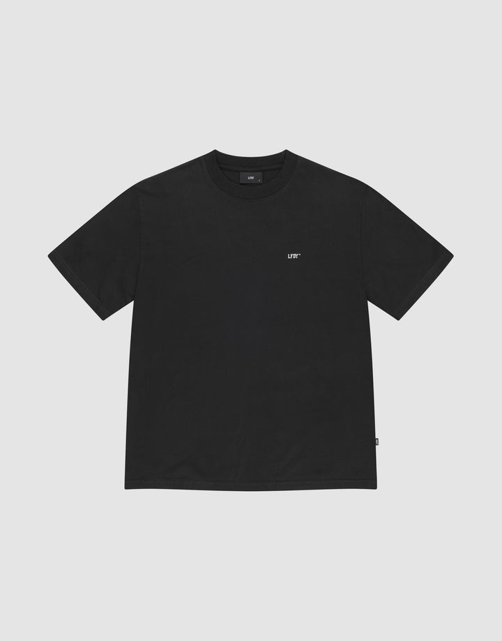 The Basic Chest Tee by LIVE FAST DIE YOUNG is a plain black regular fit, short-sleeve t-shirt in 100% cotton, featuring a small white LIFT logo below the collar. The shirt is displayed flat on a light gray background. | plain