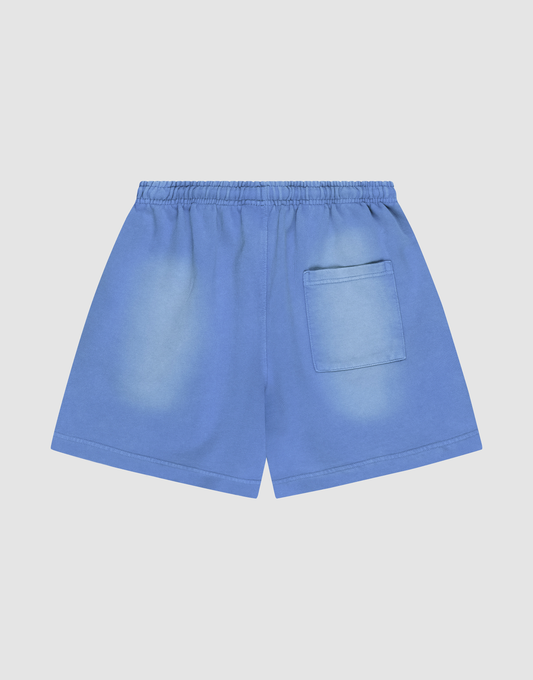 LIVE FAST DIE YOUNG Basic Sweat Shorts in blue, featuring an elastic waistband, single right back pocket, and oversized fit for comfort. The fabric has lightly faded areas for a relaxed, worn-in style and is showcased on a plain light background.