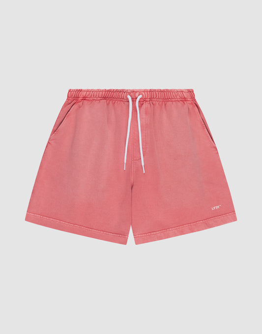 The LIVE FAST DIE YOUNG Basic Sweat Shorts in coral pink feature side pockets, a white drawstring waistband, and a subtle logo on the lower left leg, shown flat on a light background for a minimalist look. | plain