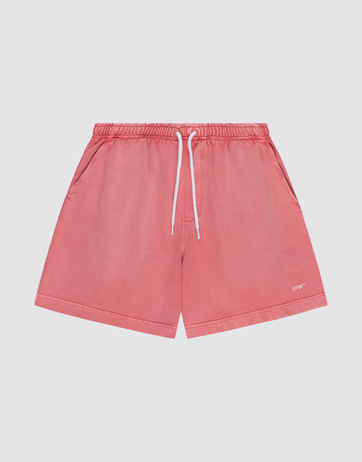 The LIVE FAST DIE YOUNG Basic Sweat Shorts in coral pink feature side pockets, a white drawstring waistband, and a subtle logo on the lower left leg, shown flat on a light background for a minimalist look. | plain