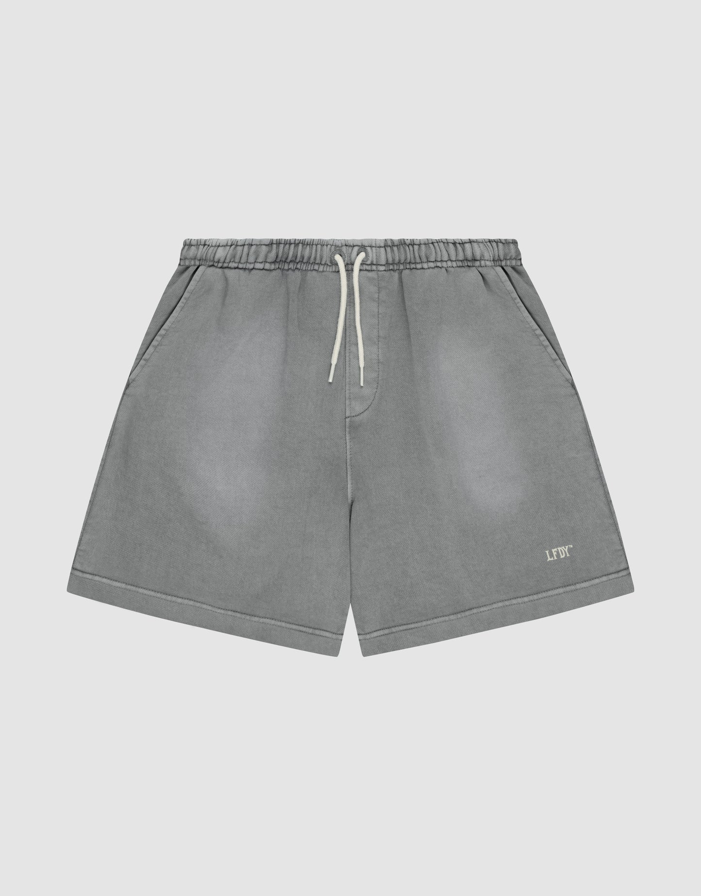 The LIVE FAST DIE YOUNG Basic Sweat Shorts feature a faded gray look, elastic waistband, side pockets, and a small logo print on the left leg, shown against a plain light background.