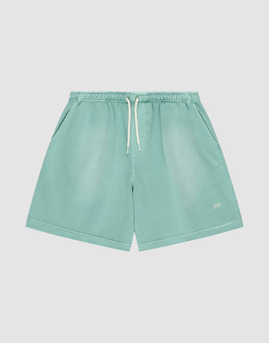 LIVE FAST DIE YOUNG Basic Sweat Shorts in light teal, featuring an elastic waistband, side pockets, and a white “LFT” logo on the bottom left leg, shown against a plain white background. | plain