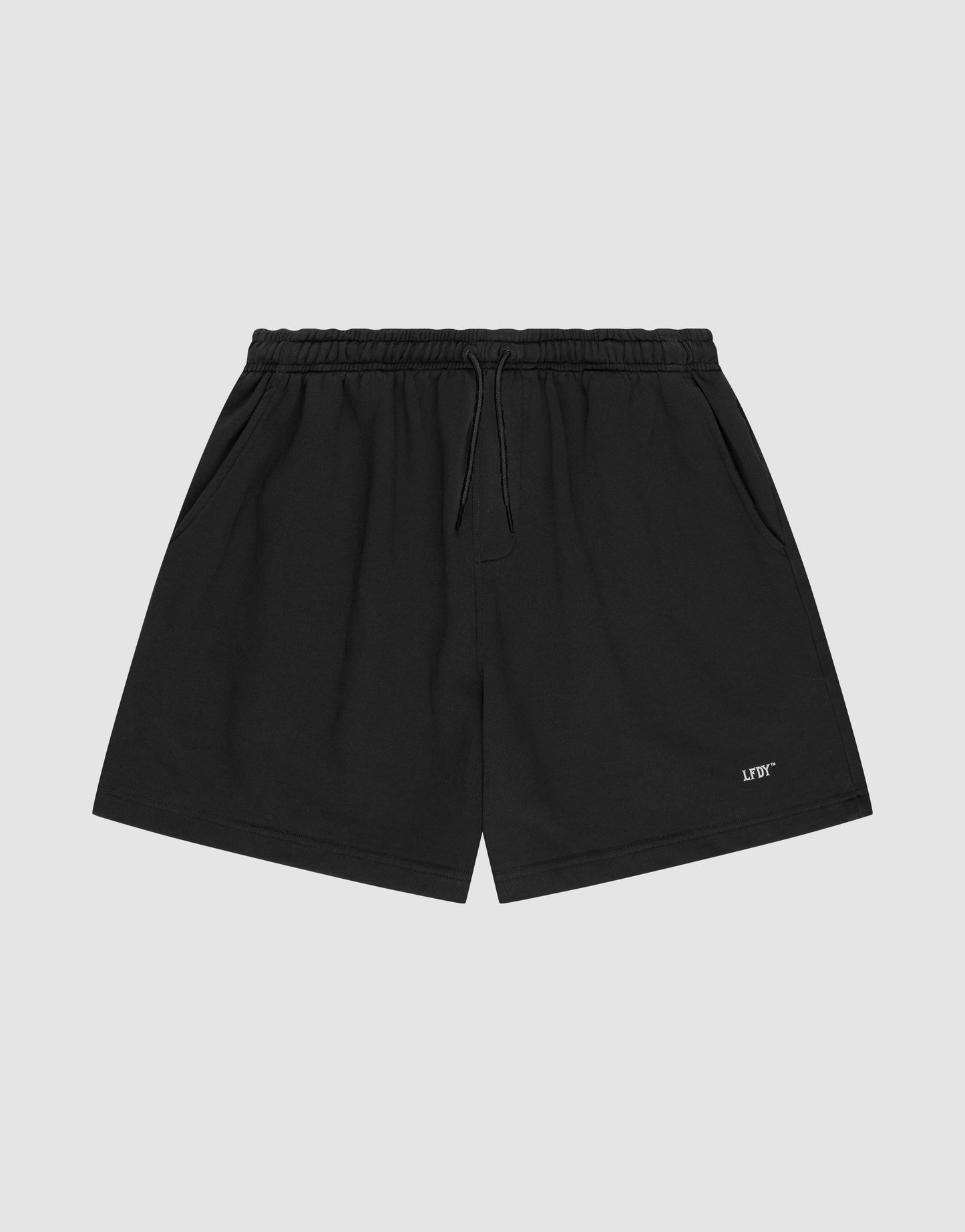 LIVE FAST DIE YOUNG Basic Sweat Shorts in plain black, featuring an elastic waistband, drawstring, side pockets, and a small white logo print on the left leg, shown on a light gray background.