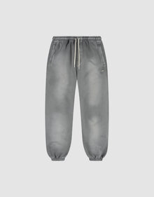 The LIVE FAST DIE YOUNG Basic Loose Jogger is a pair of gray washed sweatpants with a subtle fade effect, elastic waistband and white drawstring, side pockets, and elastic ankle cuffs, shown on a plain light background. | plain