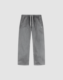 The LIVE FAST DIE YOUNG Basic Wide Jogger features a grey oversized straight-leg design with an elastic waistband, white drawstring, side pockets, and subtle logo print, shown on a plain light background. | plain