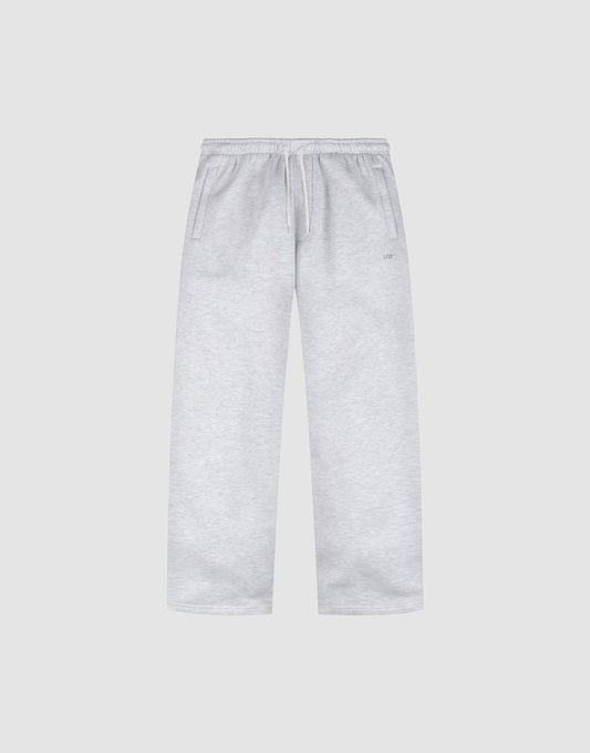 The Basic Wide Jogger by LIVE FAST DIE YOUNG features a light grey color, oversized fit, elastic waistband with drawstring, and side pockets, shown laid flat on a plain white background. | plain