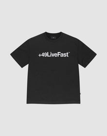 The Basic +49 Tee by LIVE FAST DIE YOUNG features a bold white +49LiveFast™ print across the chest, made from 100% cotton in an oversized fit, shown on a plain light grey background. | plain