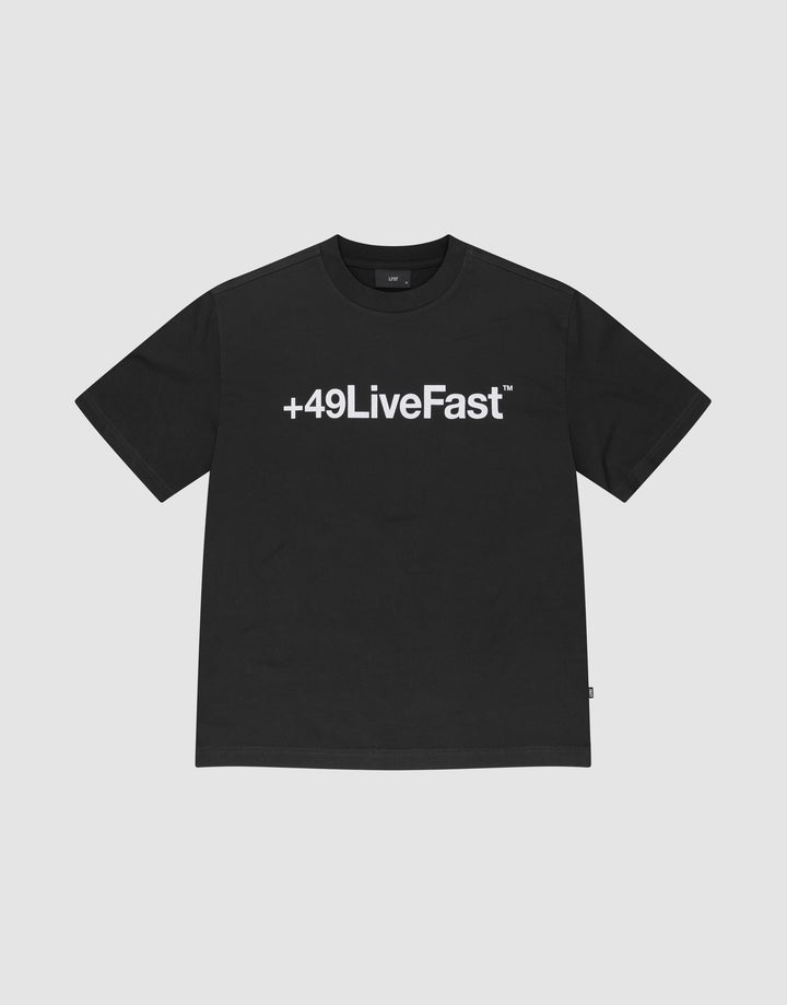 The Basic +49 Tee by LIVE FAST DIE YOUNG features a bold white +49LiveFast™ print across the chest, made from 100% cotton in an oversized fit, shown on a plain light grey background. | plain