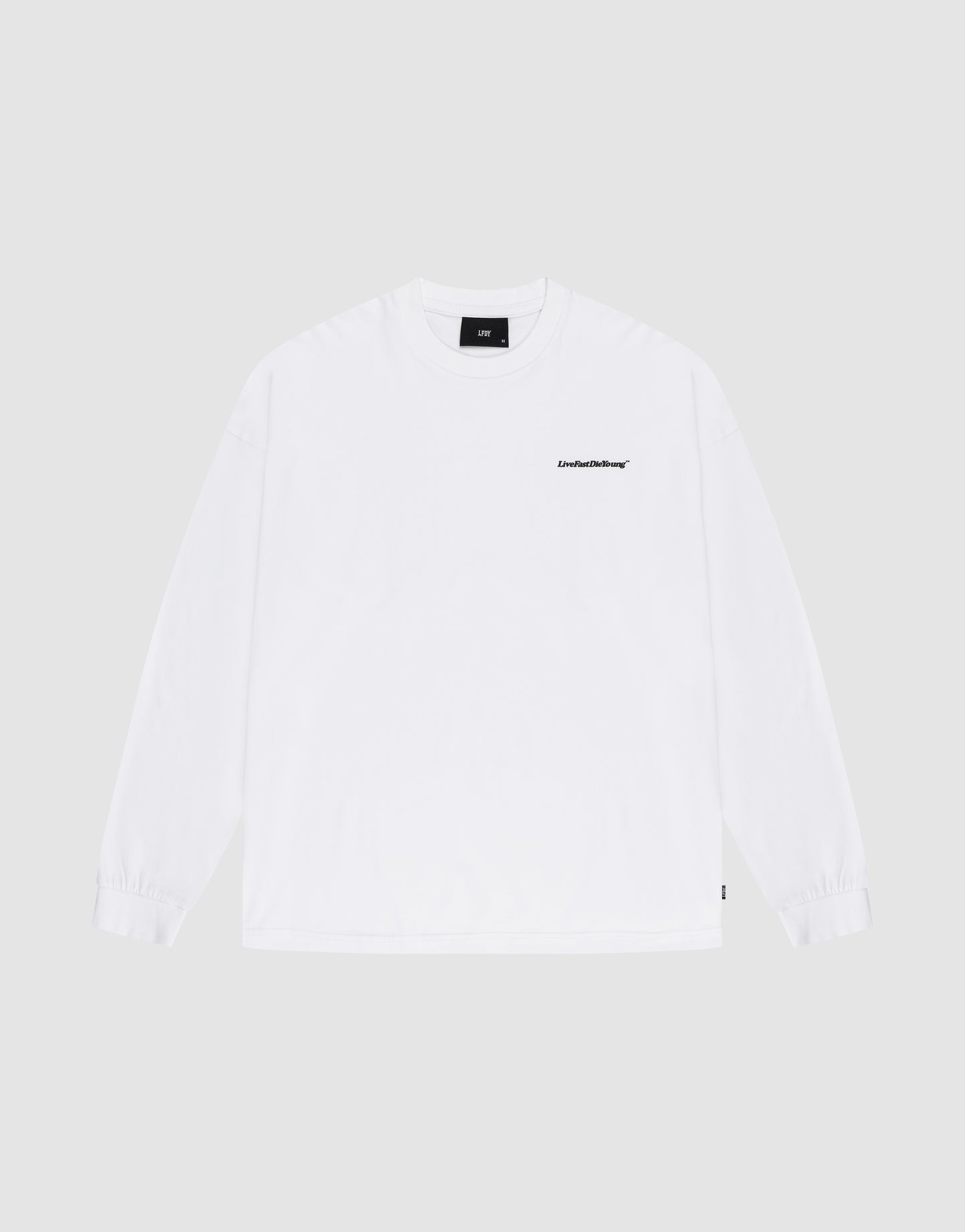 The Basic Longsleeve by LIVE FAST DIE YOUNG is an oversize white 100% Baumwolle T-shirt with a small black logo-print on the left chest, shown against a light gray background.