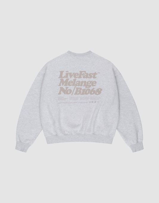 The Basic Melange Sweater by LIVE FAST DIE YOUNG is a light gray cotton sweatshirt with tan "Live Fast Melange No/B1068" backprint, crewneck, oversize fit, long sleeves, ribbed cuffs and hem, plus subtle front and backprint details. | plain