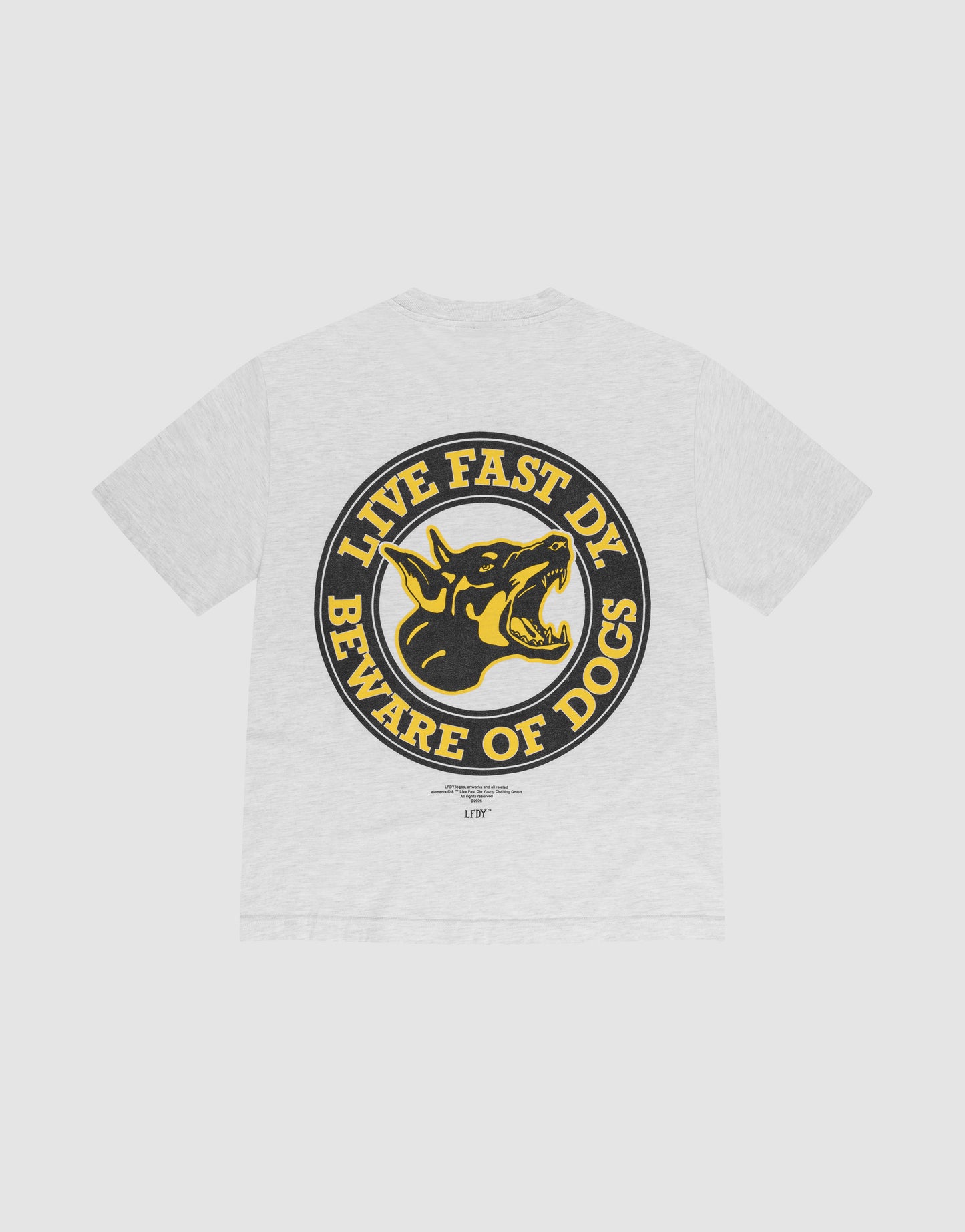 The LFDY Circle Dog Tee by LIVE FAST DIE YOUNG is a white oversize T-shirt with a bold circular back graphic of a snarling black and yellow dog and the phrases LIVE FAST DIE above and BEWARE OF DOGS below.