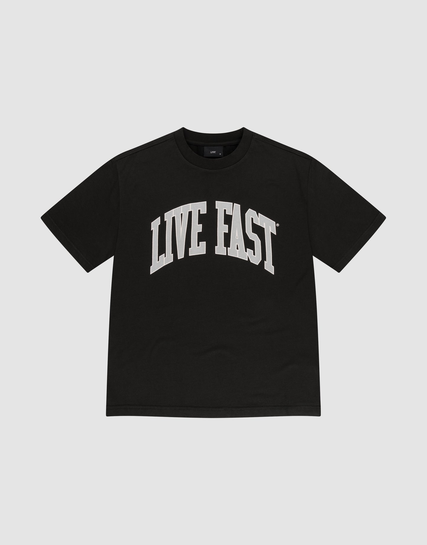 The Live Fast College Tee by LIVE FAST DIE YOUNG is a black oversized tee with LIVE FAST boldly printed in white across the chest, crafted from soft Baumwolle and shown against a plain light gray background.