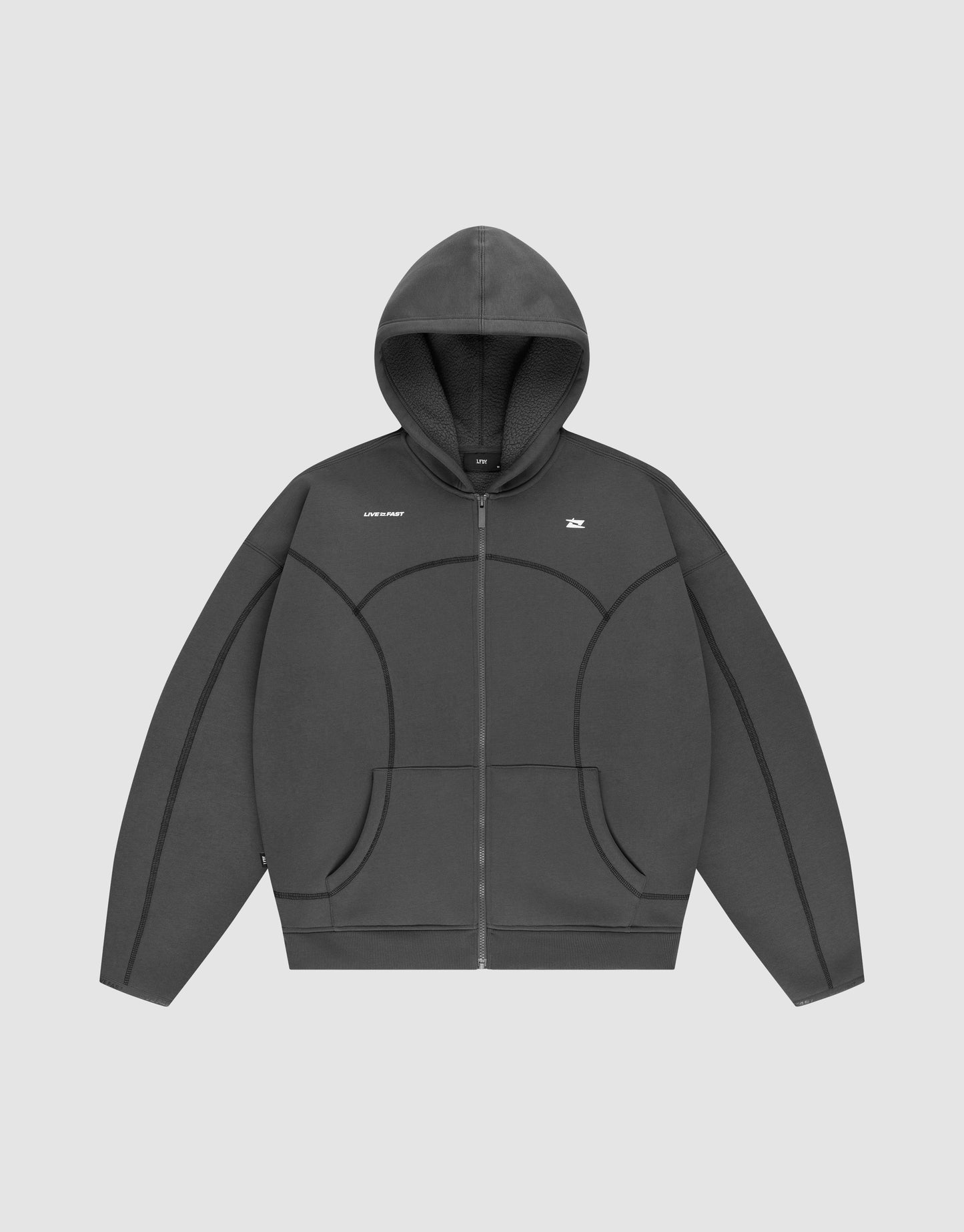 The LFDY Active Fleece Hooded Zip by LIVE FAST DIE YOUNG is a dark gray, oversized zip-up hoodie with a hood, subtle seam details, and a small white logo on the chest, shown against a plain light gray background.