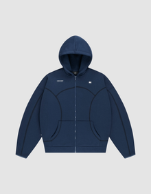 The LFDY Active Fleece Hooded Zip by LIVE FAST DIE YOUNG is a navy oversized zip-up hoodie with a hood, front pockets, black curved seams, and a small white chest logo, made from premium Baumwolle and shown on a light gray background. | plain
