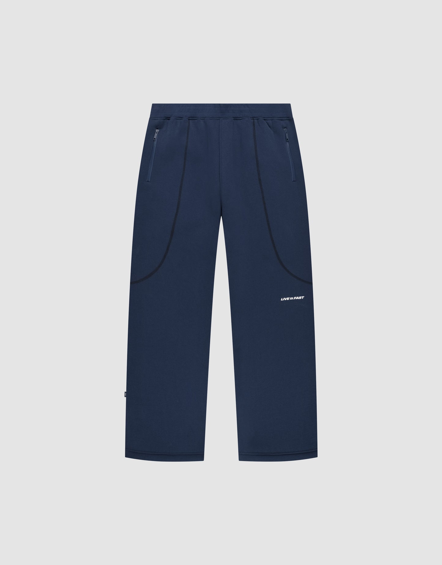 The LFDY Active Fleece Jogger by LIVE FAST DIE YOUNG features navy blue straight legs, zip pockets, subtle curved seams, a small white logo on the left thigh, and a relaxed fit. Displayed on a plain light gray background.