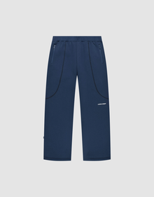 The LFDY Active Fleece Jogger by LIVE FAST DIE YOUNG features a navy blue wide fit, straight legs, zippered side pockets, black curved seam details, and a small white logo on the right thigh, shown on a light gray background. | plain