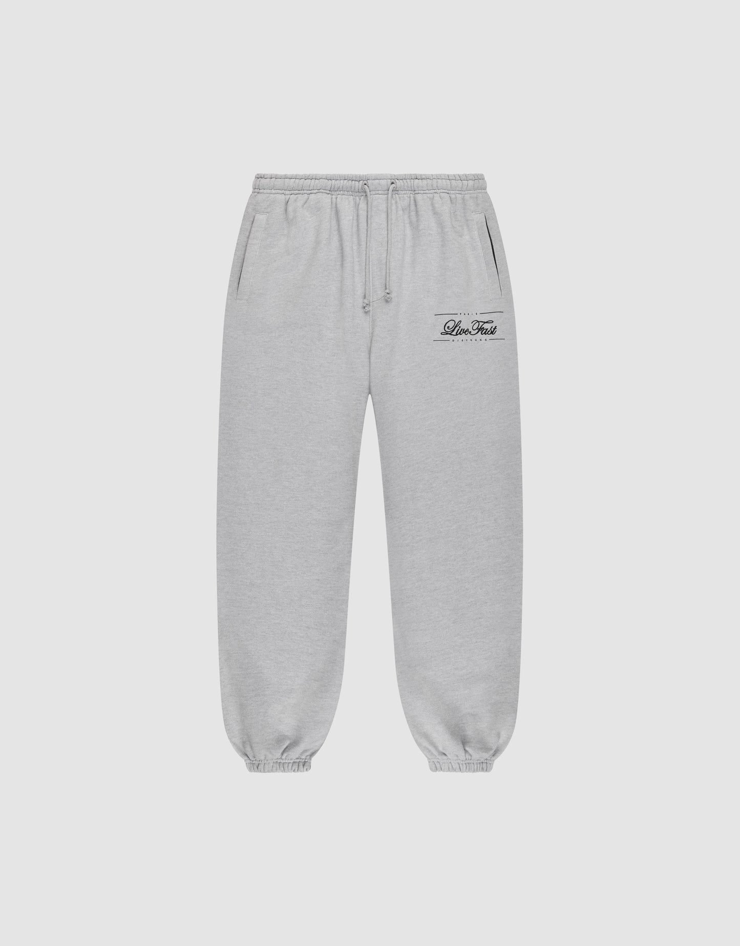 Light gray Wide Cuff Jogger sweatpants by LIVE FAST DIE YOUNG with a wide fit, elastic waistband with drawstring, side pockets, and elastic cuffs. Small black script logo on left thigh. Shown on a plain white background.