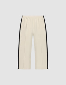 The LFDY Striped Jogger by LIVE FAST DIE YOUNG features a cream color, wide fit, elastic waistband, and black herringbone tape stripes along the sides, shown against a plain white background. | plain