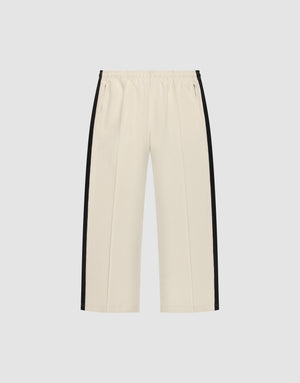 The LFDY Striped Jogger by LIVE FAST DIE YOUNG features a cream color, wide fit, elastic waistband, and black herringbone tape stripes along the sides, shown against a plain white background. | plain
