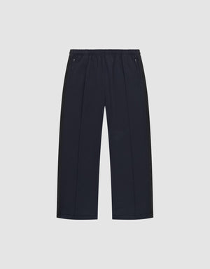 The LFDY Striped Jogger by LIVE FAST DIE YOUNG is a pair of black, wide-leg pants with an elastic waistband and zippered side pockets, featuring subtle Fischgräten-Tape accents, shown on a plain white background. | plain